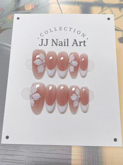 JJ Nail Art nail art collection on a white card with floral designs.