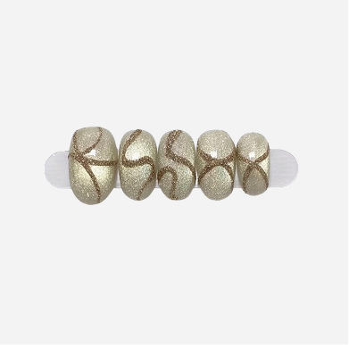 Set of decorative beads with gold and white design on a white background