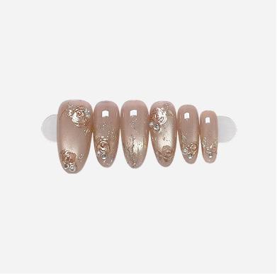 Set of decorative false nails with a rose gold and silver design on a white background