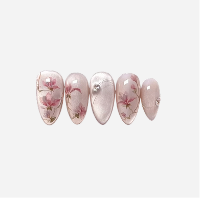 Set of five press-on nails with floral design on a white background