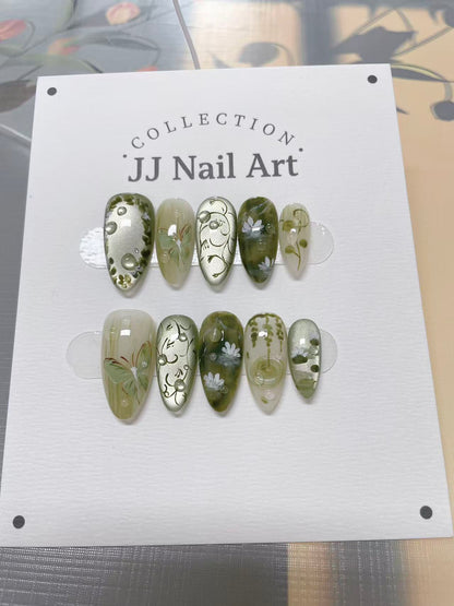 JJ Nail Art nail art collection on a display card with a blurred background